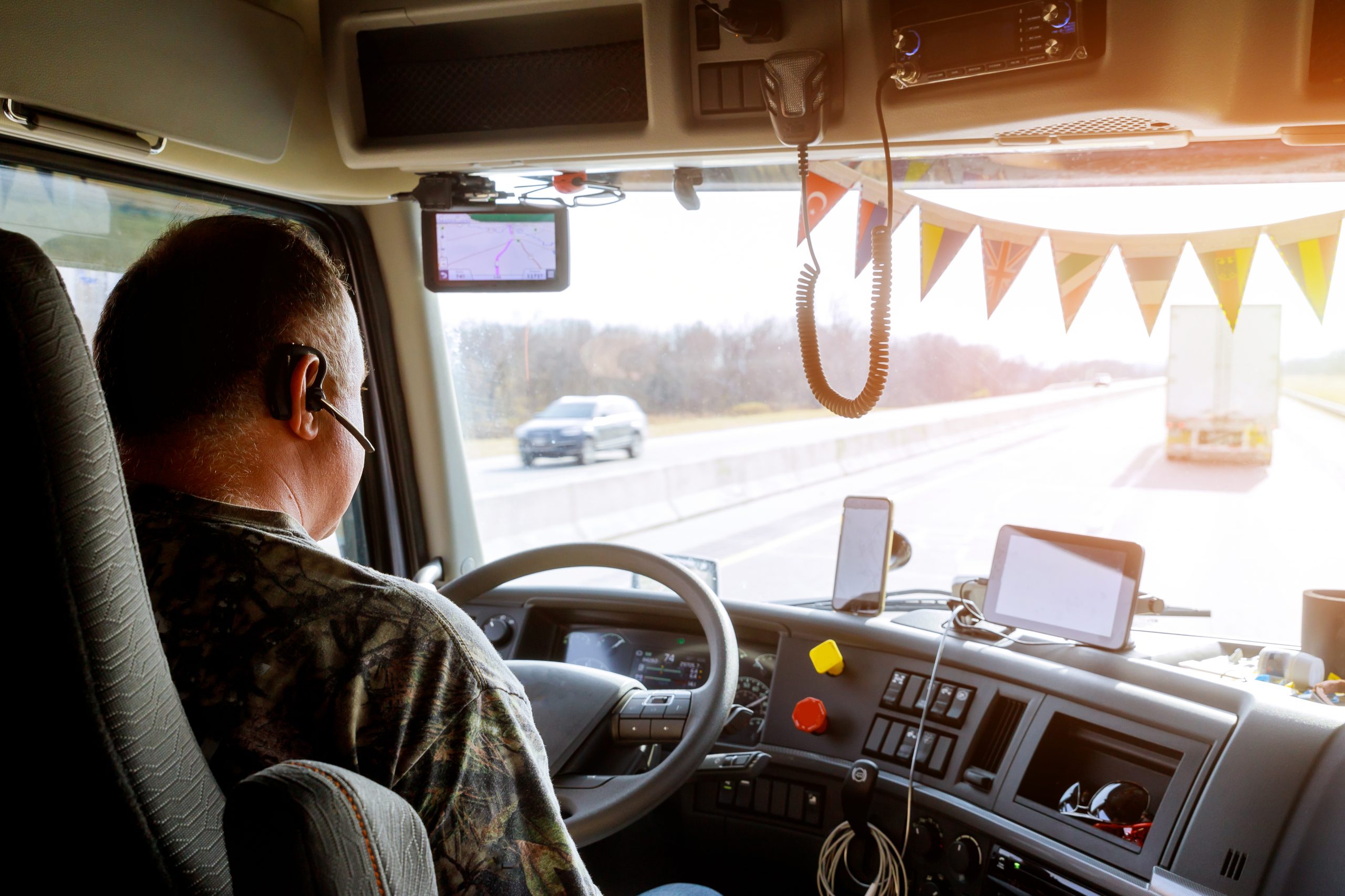 Driver in cabin of big modern truck Driver in cabin of big modern truck vehicle on highway