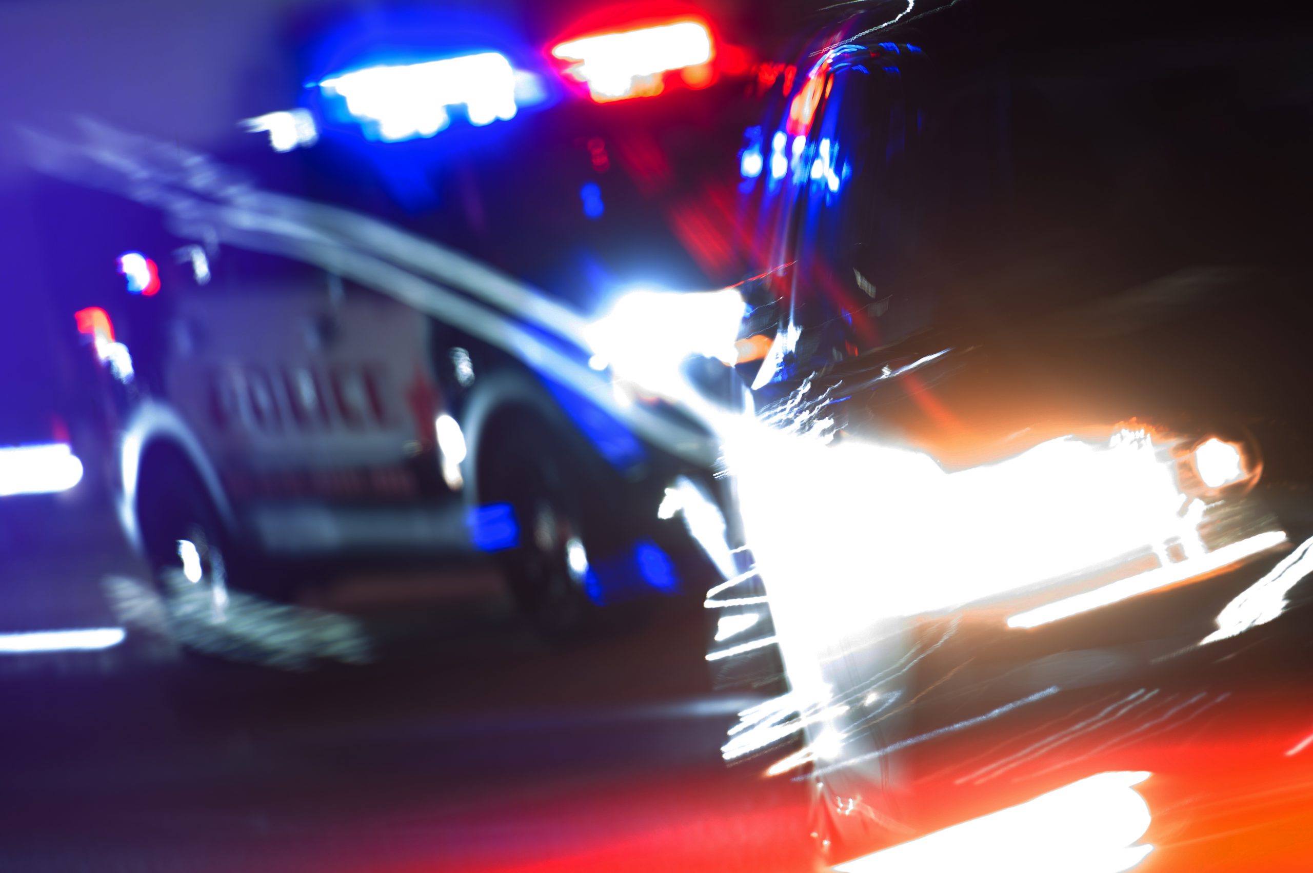 Hot Pursuit Police Traffic Chase at Night Hot Pursuit Police Traffic Chase at Night. Police Cruiser Next to Running Out DUI Driver Conceptual Photo with Motion Blurs. Police Enforcement Theme.