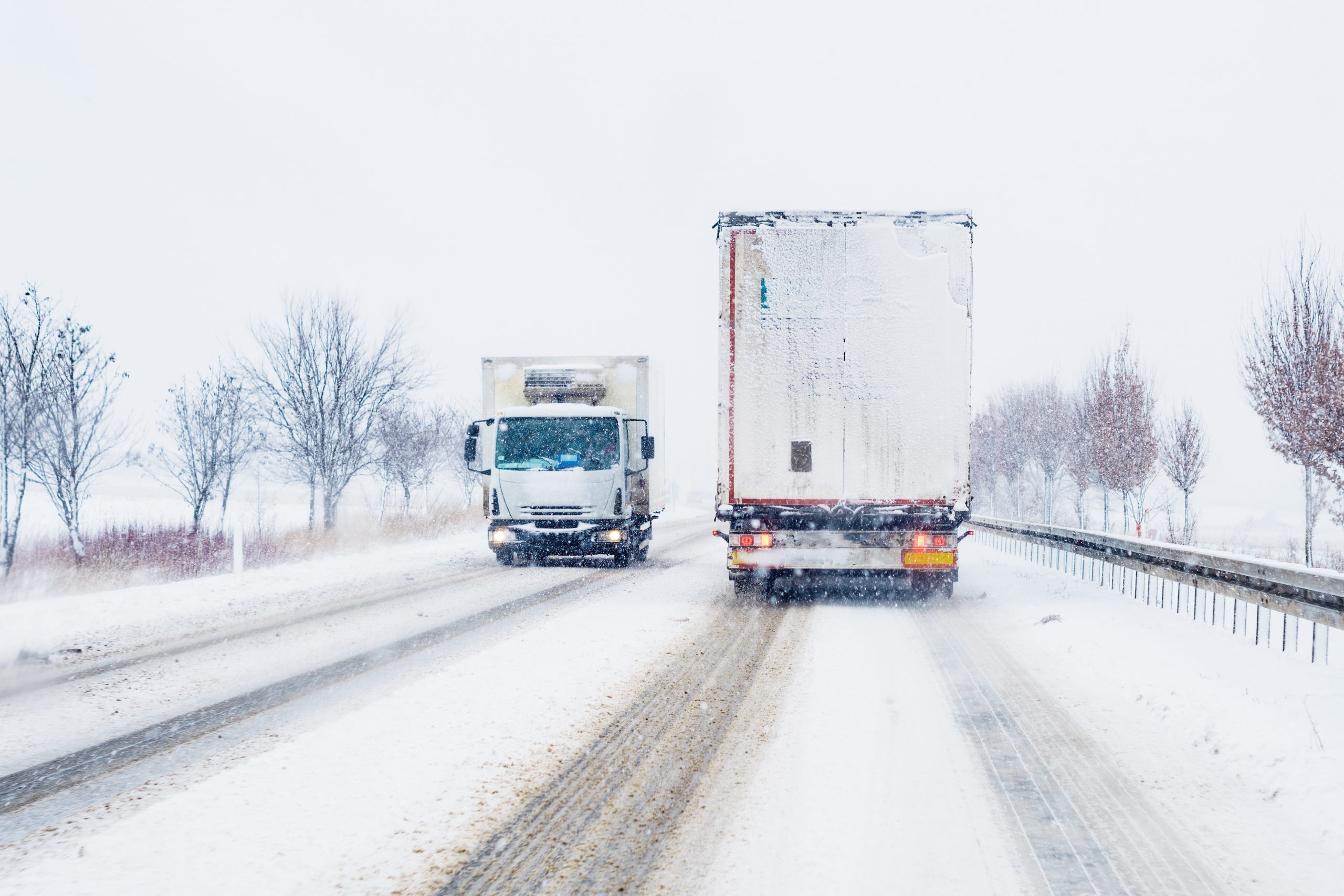 Freight transportation truck on the road in snow storm blizzard Freight transportation truck on the road in snow storm blizzard, bad weather conditions for transportation event, selective focus