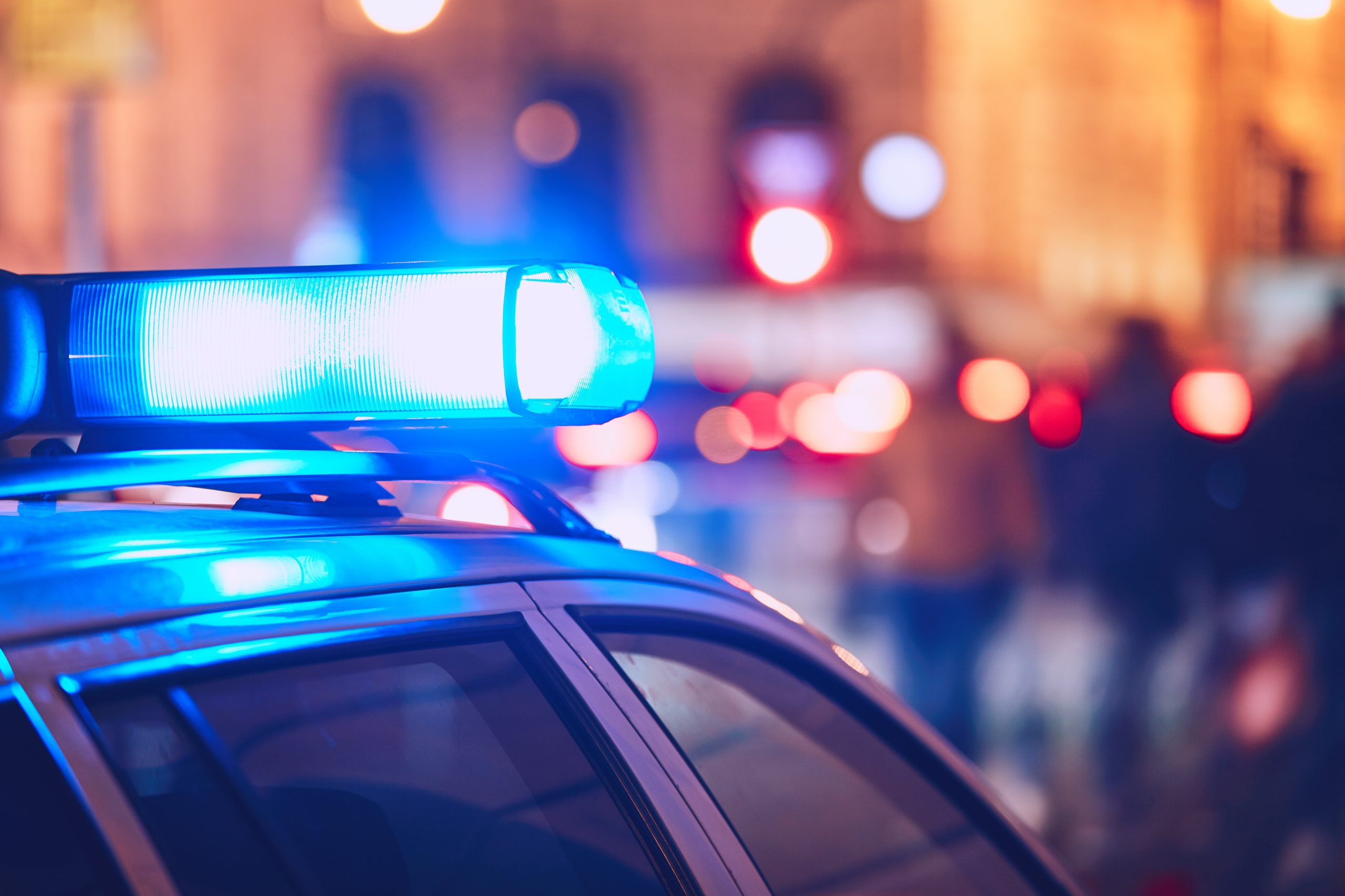 Police car on the street Danger on the street. Blue flasher on the police car at night.