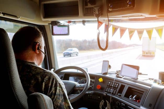 Driver in cabin of big modern truck Driver in cabin of big modern truck